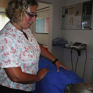 Sue Moore performs a treatment at Sidmouth Chiropractic Clinic